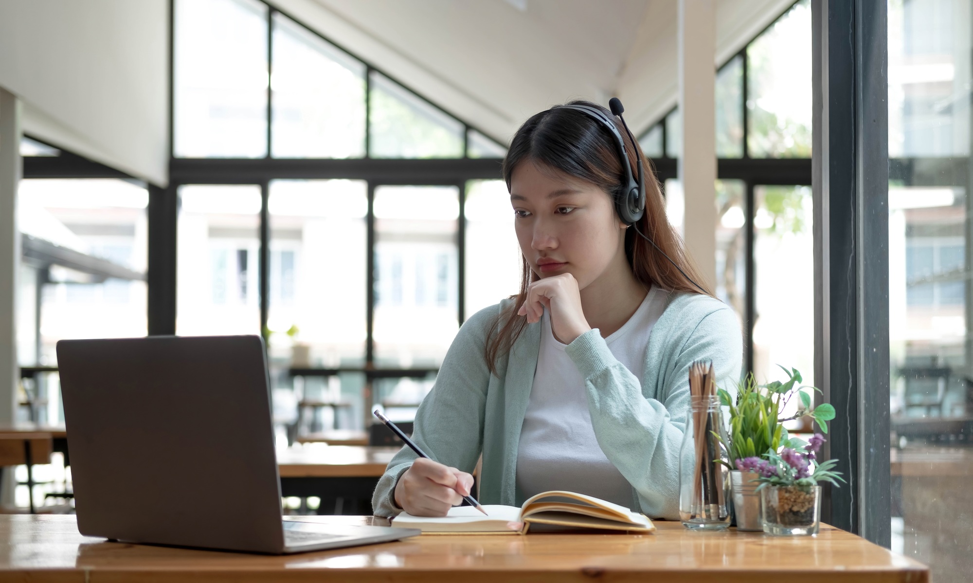 Asian woman student video conference e-learning with teacher on computer in living room at home. E